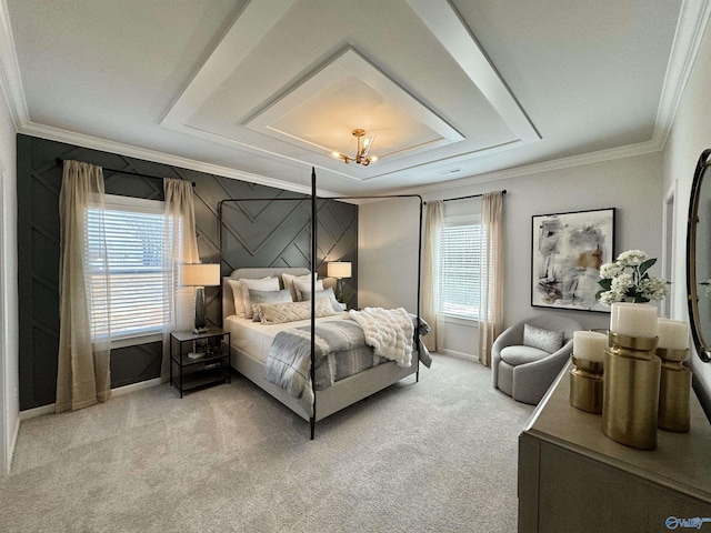 carpeted bedroom with a tray ceiling, baseboards, and crown molding