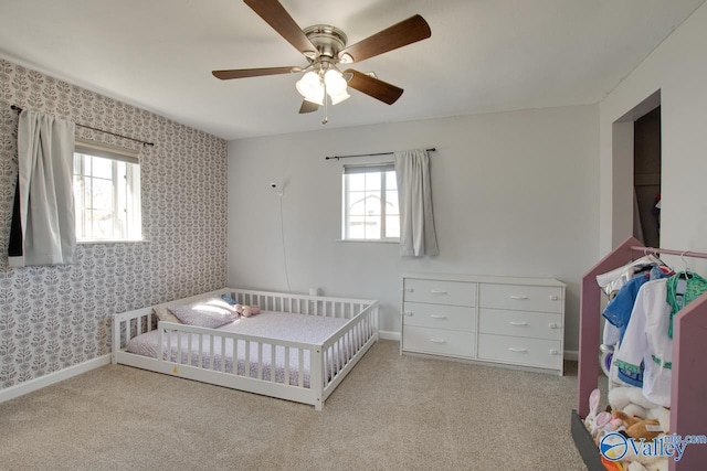 carpeted bedroom featuring ceiling fan, wallpapered walls, and baseboards