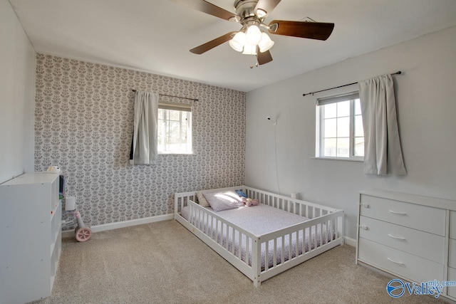 bedroom featuring baseboards, carpet floors, ceiling fan, and wallpapered walls