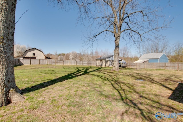 view of yard featuring an outbuilding and a fenced backyard