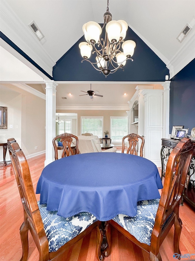 1103 Blackbriar Cir, Hartselle, AL 35640 - dining space with lofted ceiling, ornate columns, a chandelier, light wood finished floors, and plenty of natural light