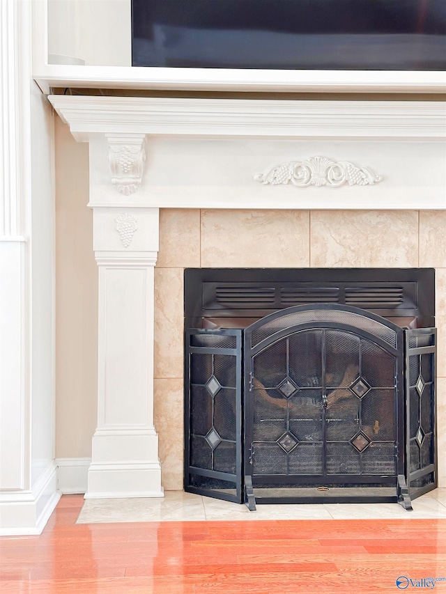 1103 Blackbriar Cir, Hartselle, AL 35640 - detailed view of wood finished floors, a tile fireplace, and baseboards