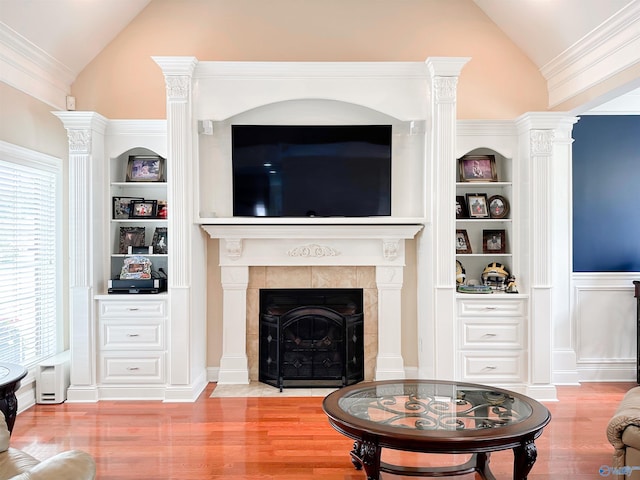 1103 Blackbriar Cir, Hartselle, AL 35640 - living room with wood finished floors, built in shelves, a tile fireplace, high vaulted ceiling, and decorative columns