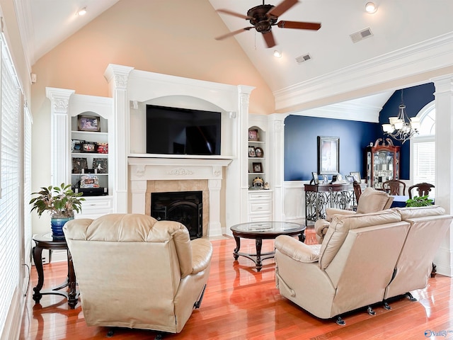 1103 Blackbriar Cir, Hartselle, AL 35640 - living room with a ceiling fan, high vaulted ceiling, wood finished floors, a tiled fireplace, and a chandelier