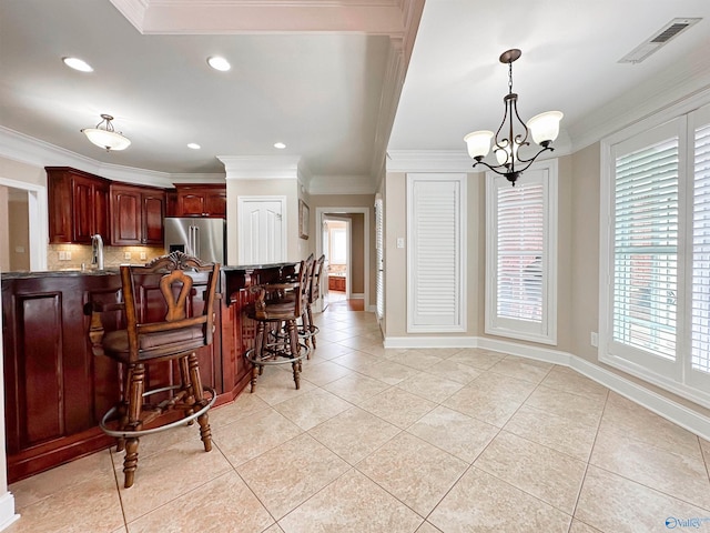1103 Blackbriar Cir, Hartselle, AL 35640 - kitchen with stainless steel fridge, ornamental molding, light tile patterned floors, healthy amount of natural light, and recessed lighting
