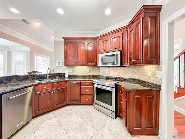 1103 Blackbriar Cir, Hartselle, AL 35640 - kitchen featuring stainless steel appliances, crown molding, a sink, dark brown cabinets, and backsplash