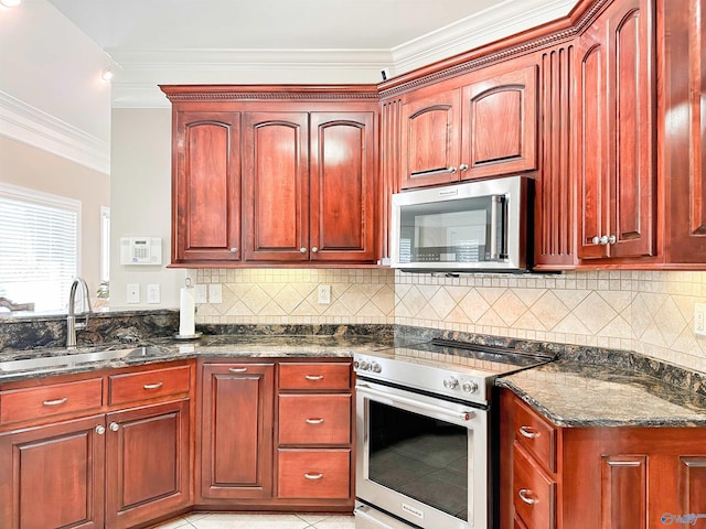 1103 Blackbriar Cir, Hartselle, AL 35640 - kitchen featuring stainless steel appliances, dark brown cabinets, a sink, crown molding, and dark stone countertops