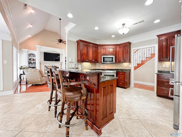 1103 Blackbriar Cir, Hartselle, AL 35640 - kitchen with appliances with stainless steel finishes, light tile patterned flooring, ceiling fan, a peninsula, and crown molding