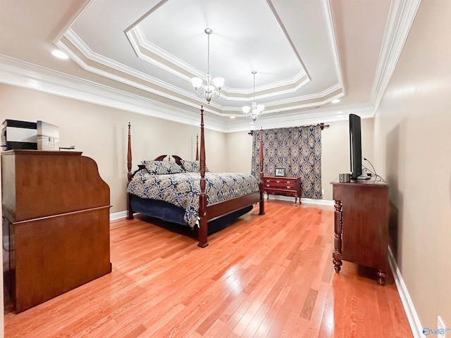 1103 Blackbriar Cir, Hartselle, AL 35640 - bedroom featuring a tray ceiling, light wood-style flooring, crown molding, baseboards, and a chandelier