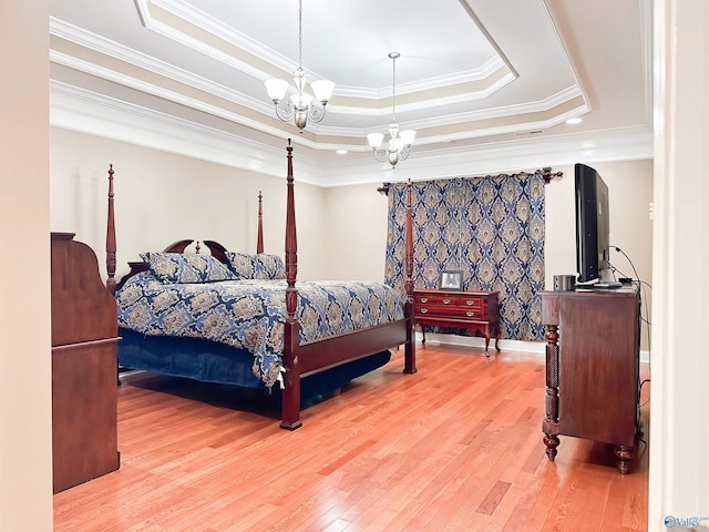 1103 Blackbriar Cir, Hartselle, AL 35640 - bedroom with a raised ceiling, wood finished floors, a chandelier, and crown molding