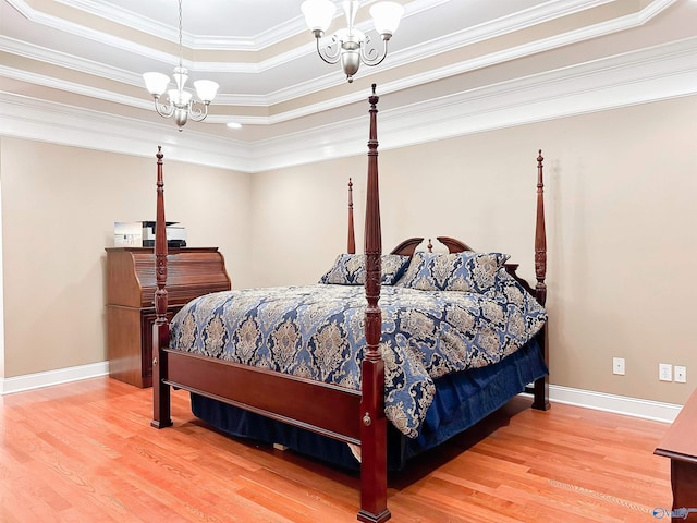 1103 Blackbriar Cir, Hartselle, AL 35640 - bedroom featuring a chandelier, wood finished floors, a tray ceiling, baseboards, and ornamental molding