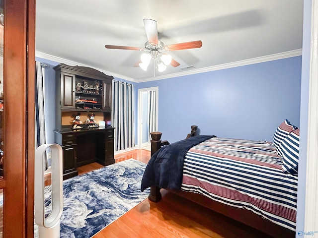 1103 Blackbriar Cir, Hartselle, AL 35640 - bedroom featuring wood finished floors, ornamental molding, and ceiling fan