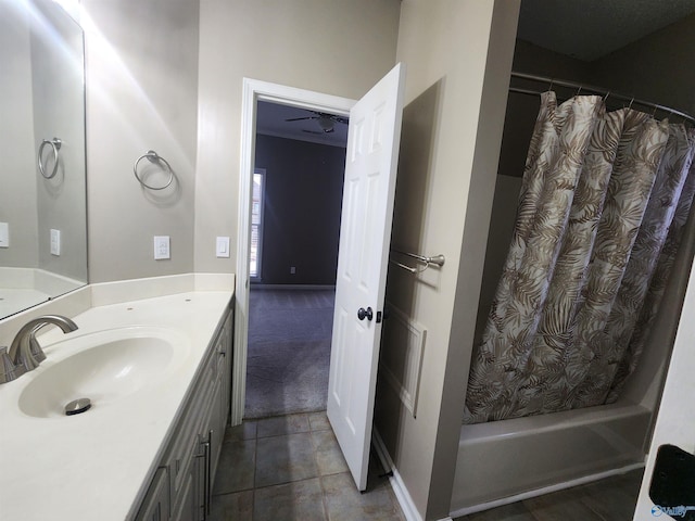 bathroom featuring shower / bath combo with shower curtain, tile patterned flooring, vanity, and a ceiling fan