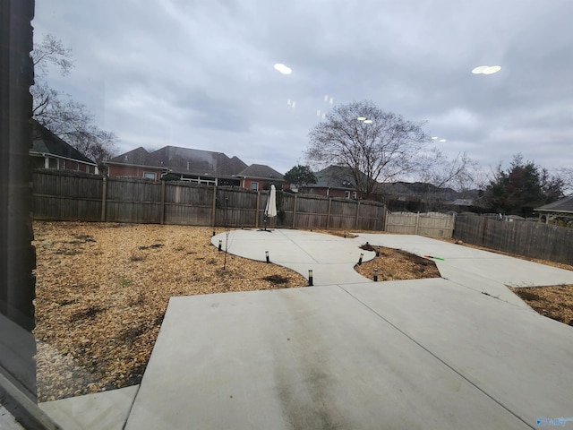view of yard with a fenced backyard and a patio