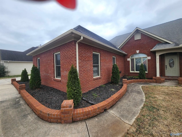 view of property exterior featuring brick siding