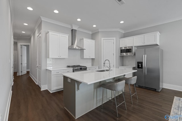 kitchen featuring white cabinets, sink, wall chimney exhaust hood, appliances with stainless steel finishes, and dark hardwood / wood-style flooring