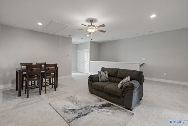 carpeted living room with ceiling fan