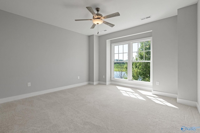 empty room with ceiling fan and light colored carpet