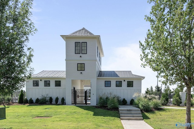 modern inspired farmhouse with a front lawn