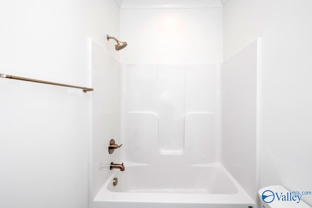 bathroom featuring toilet and  shower combination