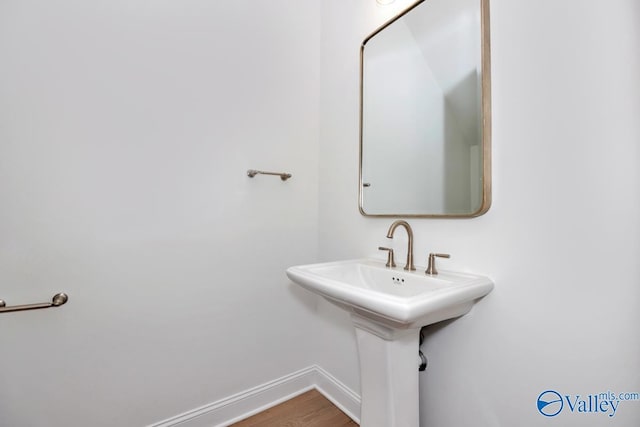 bathroom with wood-type flooring and sink