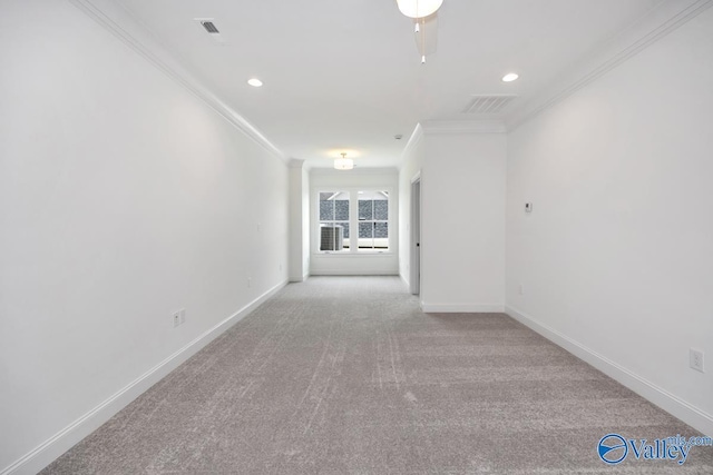 carpeted spare room featuring ornamental molding