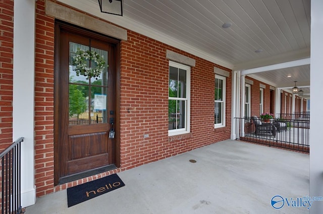 view of exterior entry with covered porch