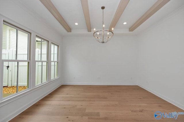 empty room featuring an inviting chandelier, light hardwood / wood-style floors, and beamed ceiling