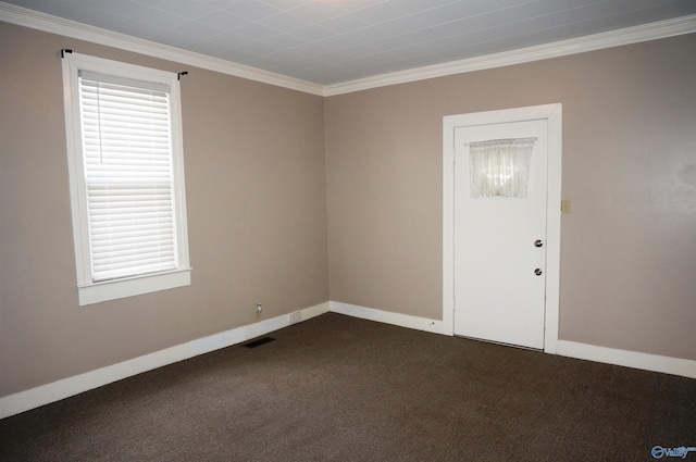 unfurnished room featuring ornamental molding, dark carpet, and baseboards