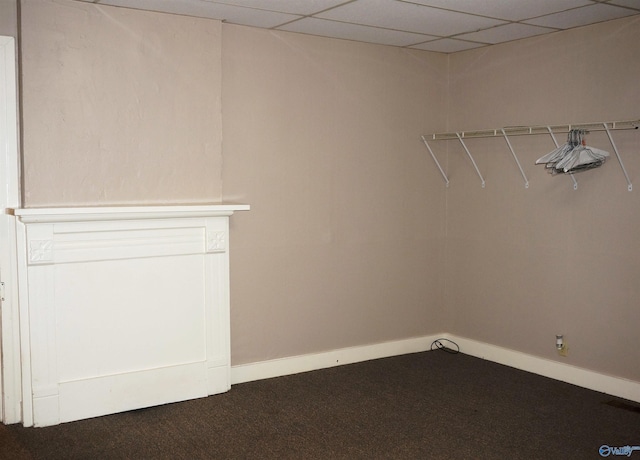 walk in closet featuring a paneled ceiling, visible vents, and dark carpet