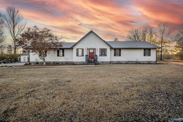 ranch-style home with a lawn