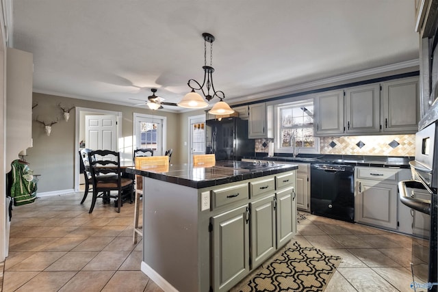 kitchen featuring ceiling fan, a center island, black appliances, decorative backsplash, and light tile patterned floors