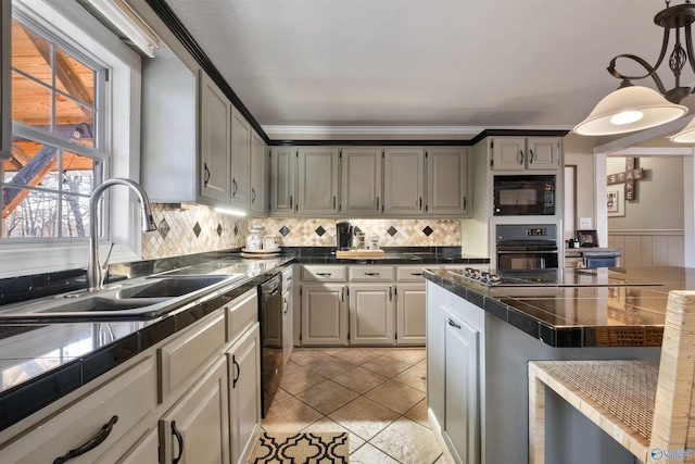 kitchen featuring pendant lighting, black appliances, sink, ornamental molding, and light tile patterned floors