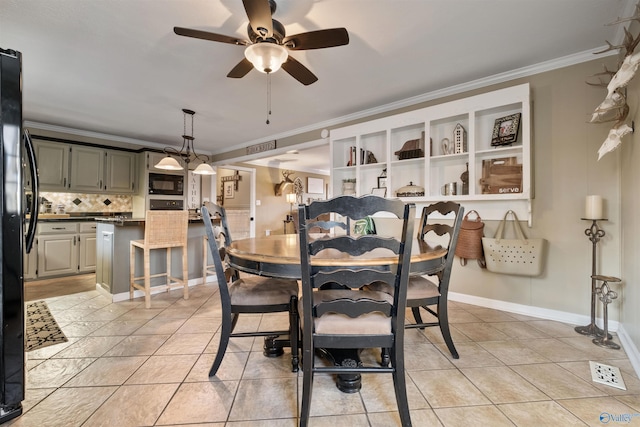 dining room featuring ceiling fan, light tile patterned floors, and ornamental molding