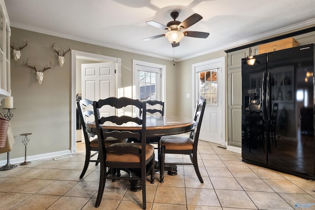 dining room with light tile patterned flooring, ceiling fan, and ornamental molding