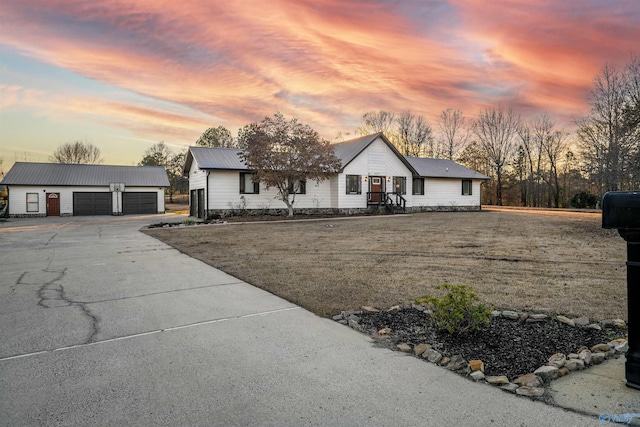 ranch-style home with a yard and a garage