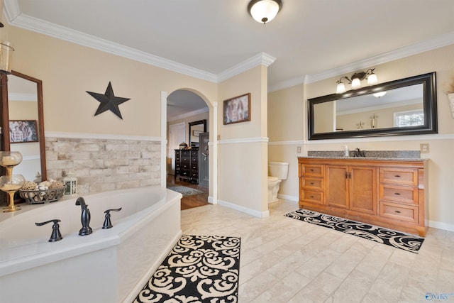 bathroom with toilet, vanity, a bathtub, and ornamental molding