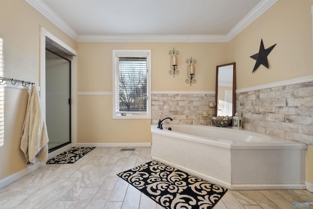 bathroom with a bathing tub and crown molding