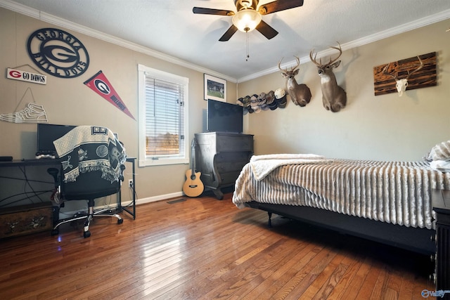 bedroom featuring ceiling fan, ornamental molding, and hardwood / wood-style flooring