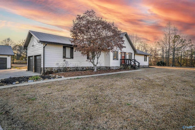 view of front of property with a lawn and a garage