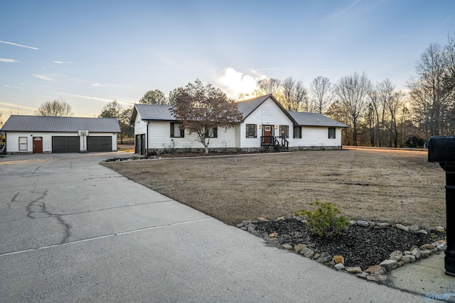 view of front of home with a garage and an outdoor structure