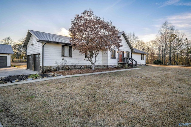 view of front of property featuring a garage and a lawn