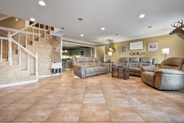 living room featuring light tile patterned floors and ornamental molding