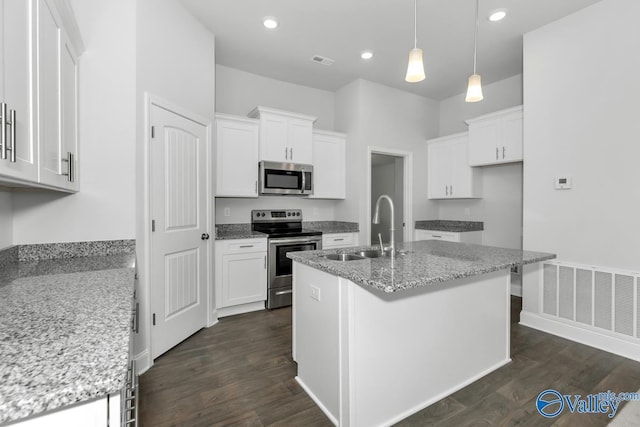 kitchen with white cabinetry, light stone countertops, sink, an island with sink, and appliances with stainless steel finishes