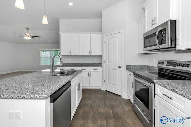 kitchen featuring a kitchen island with sink, sink, white cabinets, and stainless steel appliances