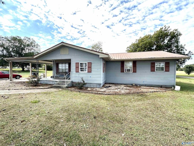 view of front facade featuring covered porch, metal roof, and a front lawn
