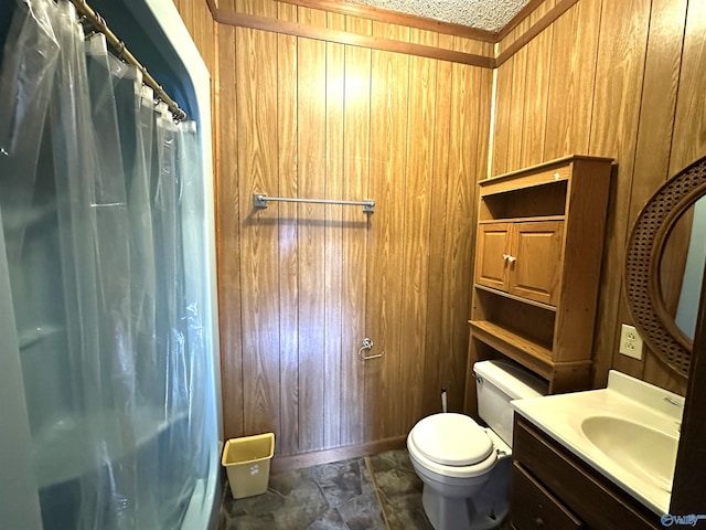 bathroom featuring wooden walls, vanity, a shower with shower curtain, toilet, and a textured ceiling