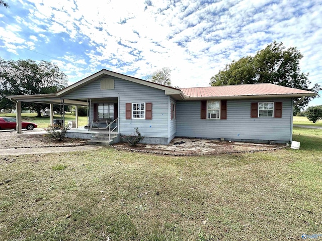 view of front of house featuring a porch, metal roof, and a front lawn