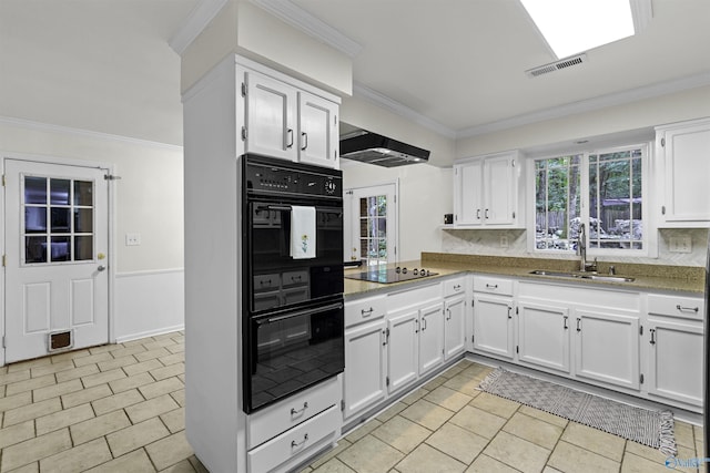 kitchen featuring under cabinet range hood, a sink, visible vents, white cabinets, and black appliances