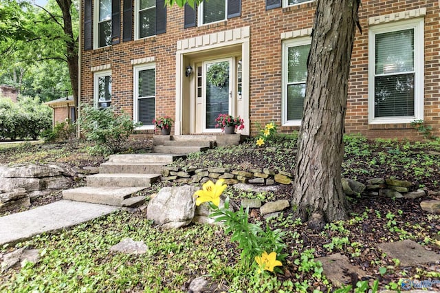 doorway to property with brick siding